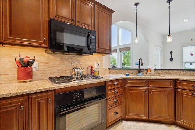 1485 Huntington Hills Dr, Marion, IA 52302 - kitchen featuring black appliances, backsplash, light stone counters, a sink, and arched walkways