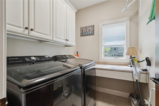 1485 Huntington Hills Dr, Marion, IA 52302 - laundry room featuring washer and dryer, cabinet space, and tile patterned flooring