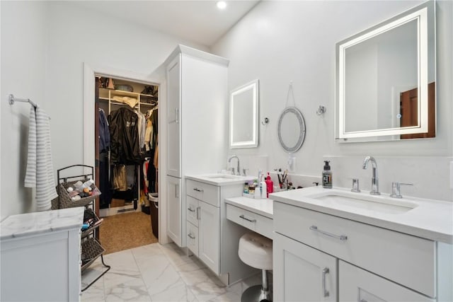 1485 Huntington Hills Dr, Marion, IA 52302 - full bathroom featuring marble finish floors, two vanities, a walk in closet, and recessed lighting