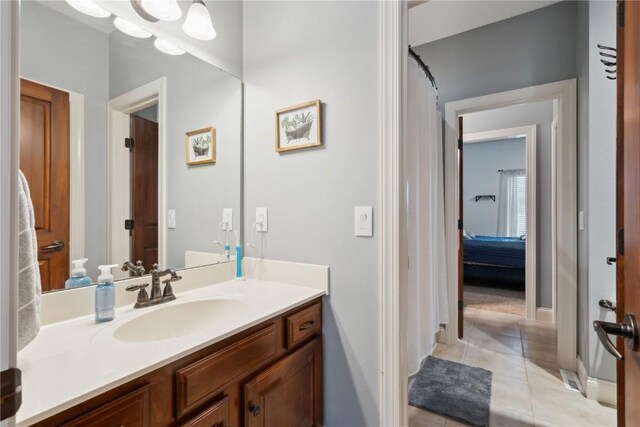 1485 Huntington Hills Dr, Marion, IA 52302 - bathroom featuring tile patterned flooring, vanity, and baseboards