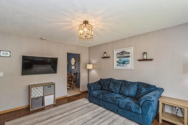 5817 Underwood SW, Cedar Rapids, IA 52404 - living room with a chandelier, wood finished floors, and baseboards