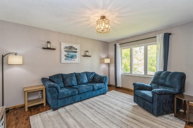 5817 Underwood SW, Cedar Rapids, IA 52404 - living area with baseboards, a chandelier, and wood finished floors