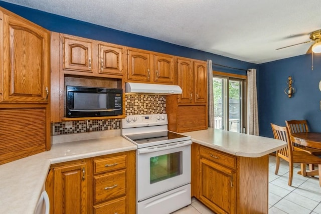 5817 Underwood SW, Cedar Rapids, IA 52404 - kitchen featuring white range with electric stovetop, under cabinet range hood, black microwave, a peninsula, and light countertops