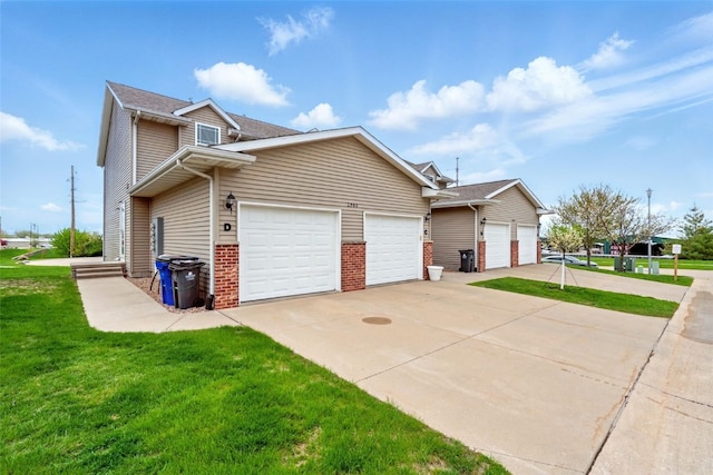 2900 Samuel Ct SW Unit D, Cedar Rapids, IA 52404 - view of side of property with driveway, a yard, a garage, and brick siding