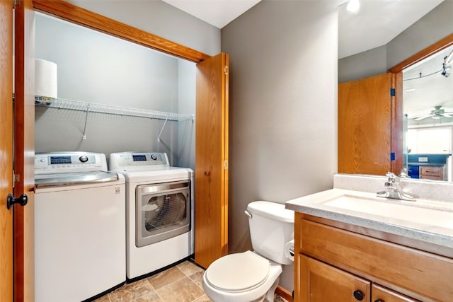 2900 Samuel Ct SW Unit D, Cedar Rapids, IA 52404 - bathroom with washing machine and clothes dryer, vanity, toilet, and ceiling fan
