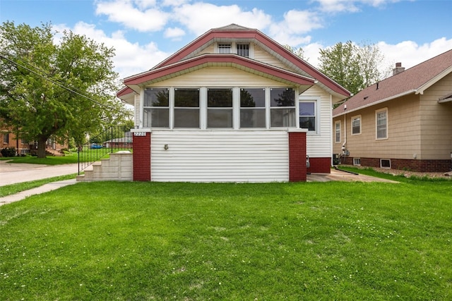 2220 D St SW, Cedar Rapids, IA 52404 - view of front of property featuring a front yard and a sunroom
