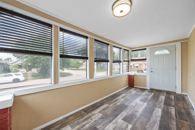 2220 D St SW, Cedar Rapids, IA 52404 - unfurnished sunroom with baseboards and wood finished floors