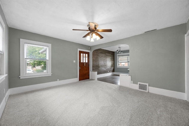 2220 D St SW, Cedar Rapids, IA 52404 - carpeted empty room featuring arched walkways, ceiling fan, and baseboards