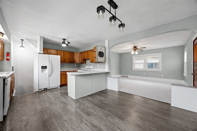 2220 D St SW, Cedar Rapids, IA 52404 - kitchen featuring white fridge with ice dispenser, a ceiling fan, open floor plan, and a peninsula