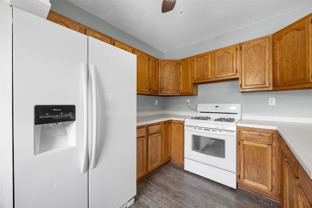 2220 D St SW, Cedar Rapids, IA 52404 - kitchen with white appliances, dark wood-style flooring, light countertops, and brown cabinets