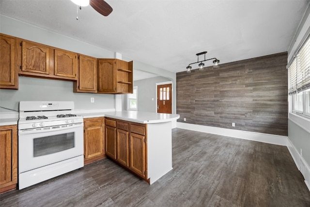 2220 D St SW, Cedar Rapids, IA 52404 - kitchen featuring white range with gas cooktop, a peninsula, open shelves, light countertops, and brown cabinets