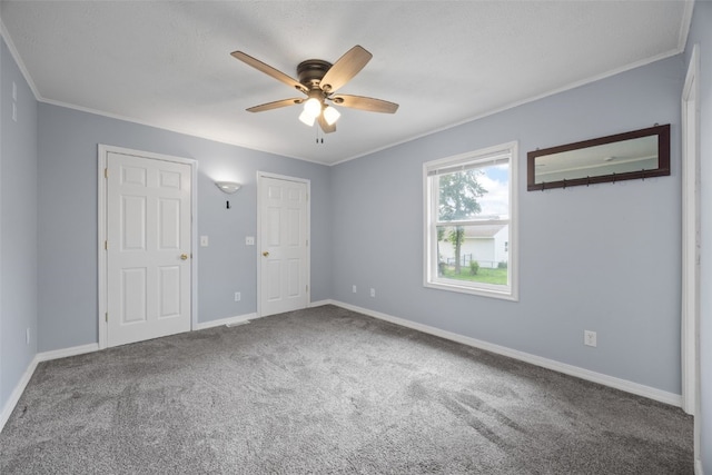 2220 D St SW, Cedar Rapids, IA 52404 - unfurnished bedroom featuring carpet, crown molding, baseboards, and a ceiling fan