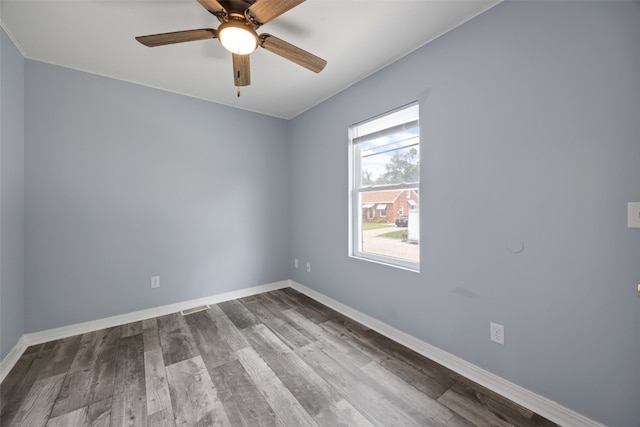 2220 D St SW, Cedar Rapids, IA 52404 - unfurnished room featuring wood finished floors, baseboards, and a ceiling fan