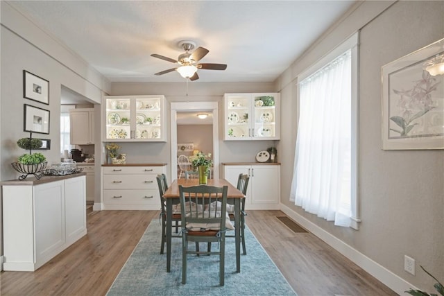 407 7th Ave SW, Cedar Rapids, IA 52404 - dining room with ceiling fan, light wood finished floors, and baseboards