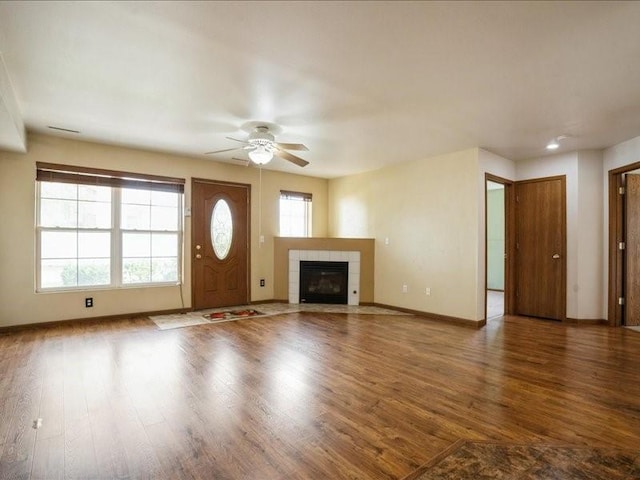 1200 Murray St NE Unit 1, Cedar Rapids, IA 52402 - unfurnished living room with ceiling fan, wood finished floors, baseboards, and a tiled fireplace