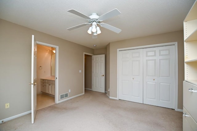 3730 Deer Valley Dr Unit B, Marion, IA 52302 - unfurnished bedroom with light colored carpet, baseboards, a closet, connected bathroom, and ceiling fan