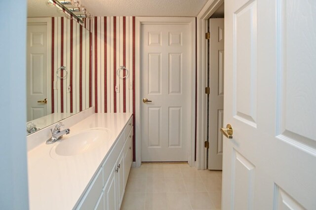 3730 Deer Valley Dr Unit B, Marion, IA 52302 - bathroom featuring vanity, tile patterned flooring, and a textured ceiling