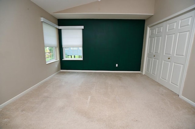3730 Deer Valley Dr Unit B, Marion, IA 52302 - unfurnished bedroom featuring carpet flooring, lofted ceiling, a closet, and baseboards