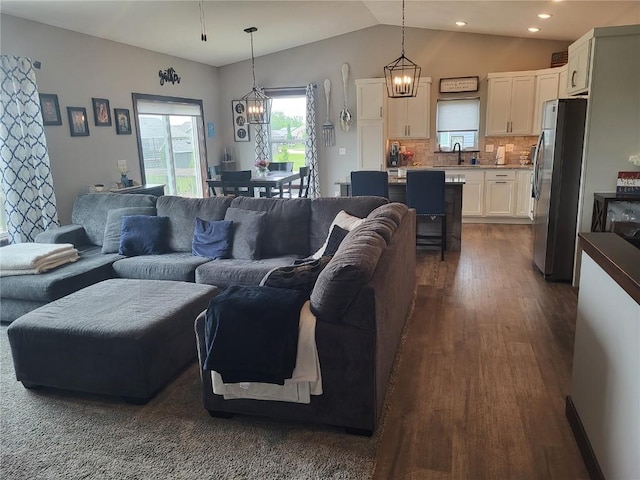 5055 Pluto Ave, Marion, IA 52302 - living room featuring dark wood finished floors, vaulted ceiling, a chandelier, and recessed lighting