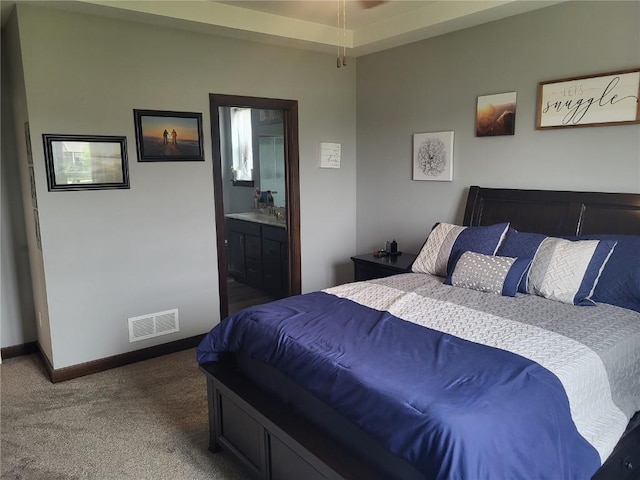 5055 Pluto Ave, Marion, IA 52302 - bedroom with carpet floors, baseboards, ensuite bath, and a sink