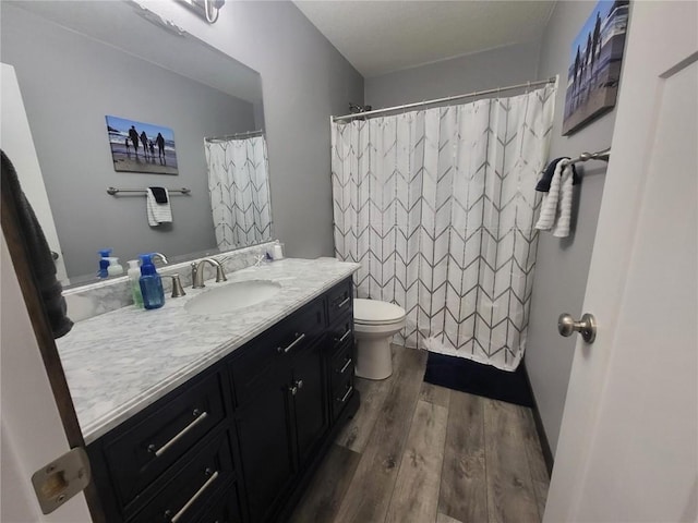 5055 Pluto Ave, Marion, IA 52302 - full bath with vanity, wood finished floors, toilet, and a shower with curtain