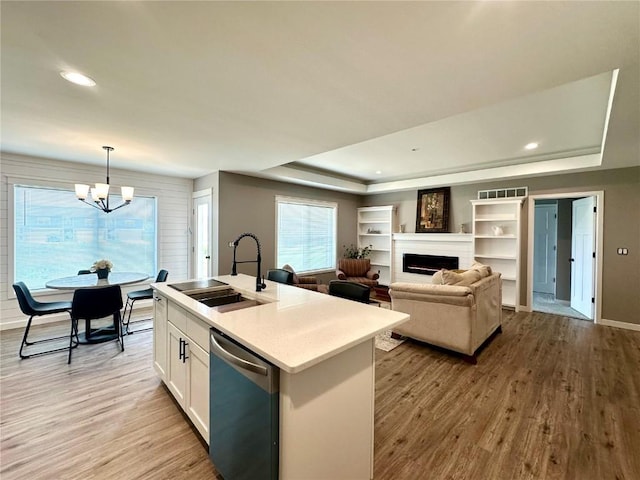 914 Juneberry Dr, Palo, IA 52324 - kitchen with dishwasher, a sink, a raised ceiling, light wood-style floors, and recessed lighting