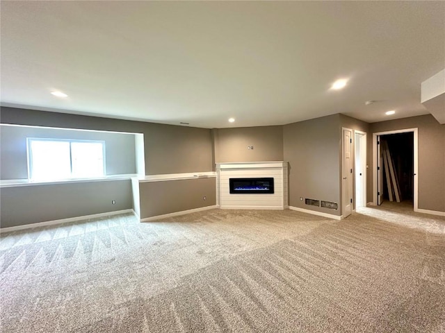 914 Juneberry Dr, Palo, IA 52324 - unfurnished living room featuring carpet flooring, baseboards, a glass covered fireplace, and recessed lighting