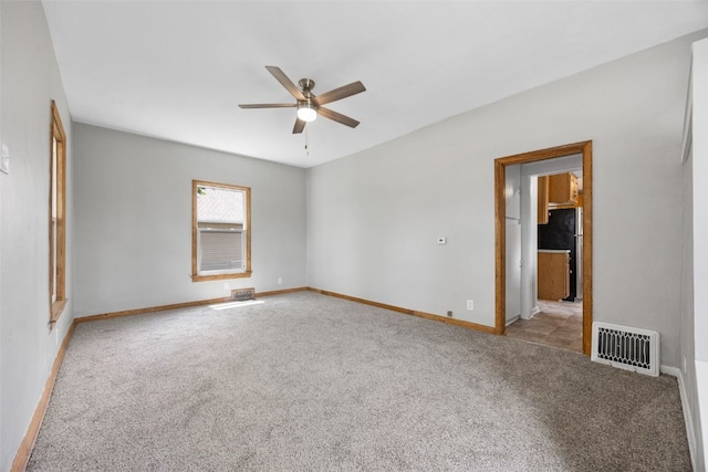 1814 9th St SW, Cedar Rapids, IA 52404 - unfurnished room with carpet, ceiling fan, and baseboards