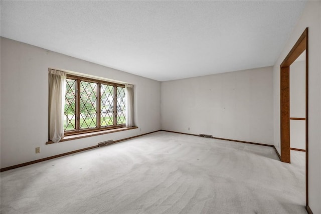 4633 Northwood Dr NE, Cedar Rapids, IA 52402 - empty room with carpet floors, baseboards, and a textured ceiling