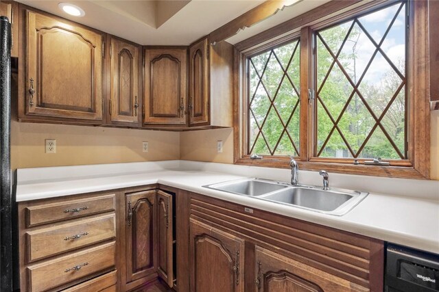 4633 Northwood Dr NE, Cedar Rapids, IA 52402 - kitchen with a sink, dishwashing machine, light countertops, recessed lighting, and brown cabinets