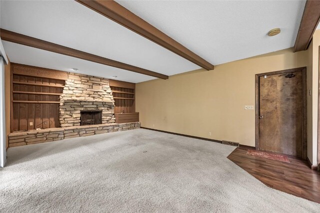 4633 Northwood Dr NE, Cedar Rapids, IA 52402 - unfurnished living room with beamed ceiling, carpet, baseboards, a stone fireplace, and built in features