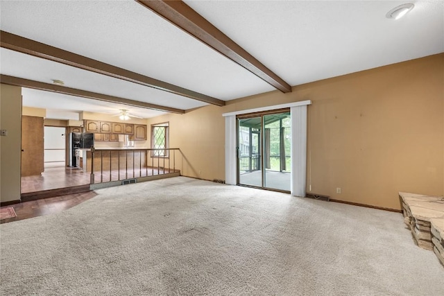 4633 Northwood Dr NE, Cedar Rapids, IA 52402 - unfurnished living room with carpet, beamed ceiling, baseboards, and ceiling fan
