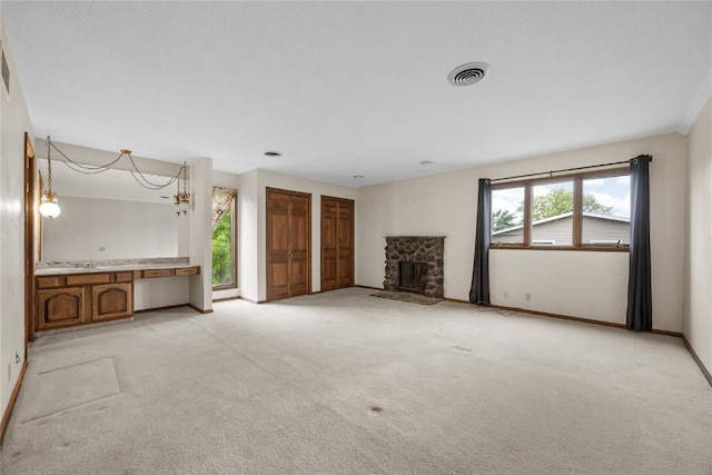 4633 Northwood Dr NE, Cedar Rapids, IA 52402 - unfurnished living room with a fireplace, light colored carpet, and baseboards