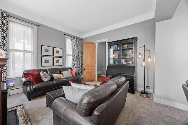 320 E St, Tipton, IA 52772 - living room featuring baseboard heating, light carpet, and baseboards