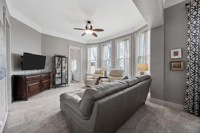 320 E St, Tipton, IA 52772 - living area with light carpet, a ceiling fan, and baseboards