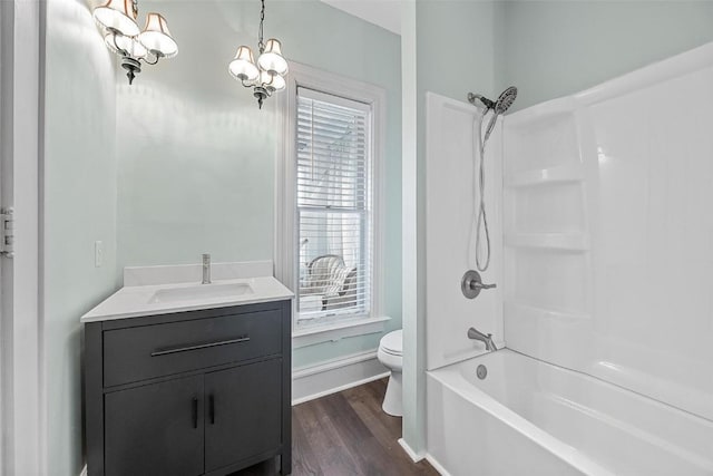 320 E St, Tipton, IA 52772 - bathroom featuring toilet, vanity, wood finished floors, shower / tub combination, and baseboards