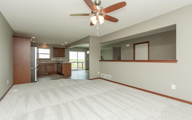 3806 English Glen Ave, Marion, IA 52302 - unfurnished living room with ceiling fan, baseboards, light colored carpet, and recessed lighting