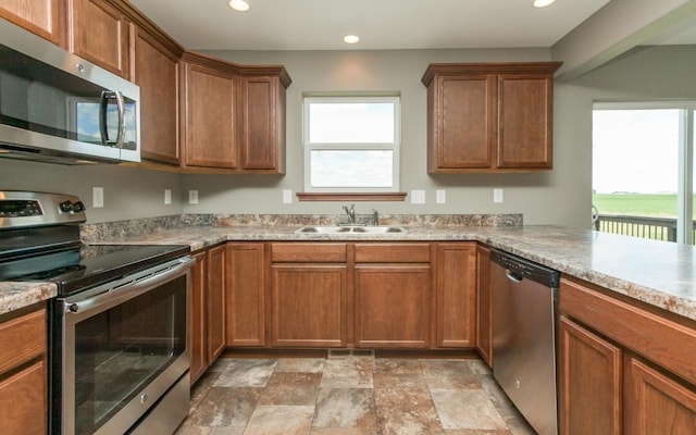 3806 English Glen Ave, Marion, IA 52302 - kitchen featuring stainless steel appliances, a sink, plenty of natural light, recessed lighting, and stone finish floors