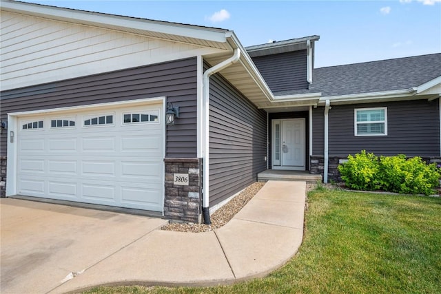 3806 English Glen Ave, Marion, IA 52302 - entrance to property with stone siding, a garage, driveway, and a lawn