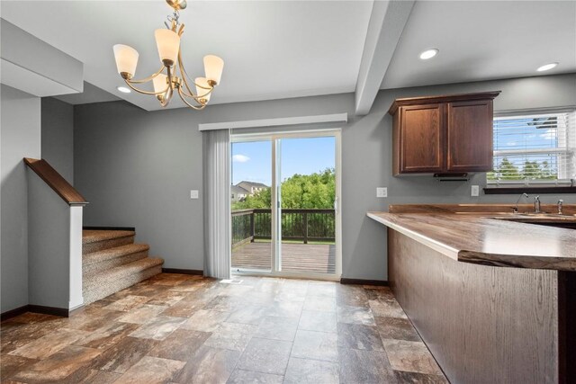 3806 English Glen Ave, Marion, IA 52302 - kitchen featuring a chandelier, stone finish flooring, recessed lighting, hanging light fixtures, and beamed ceiling