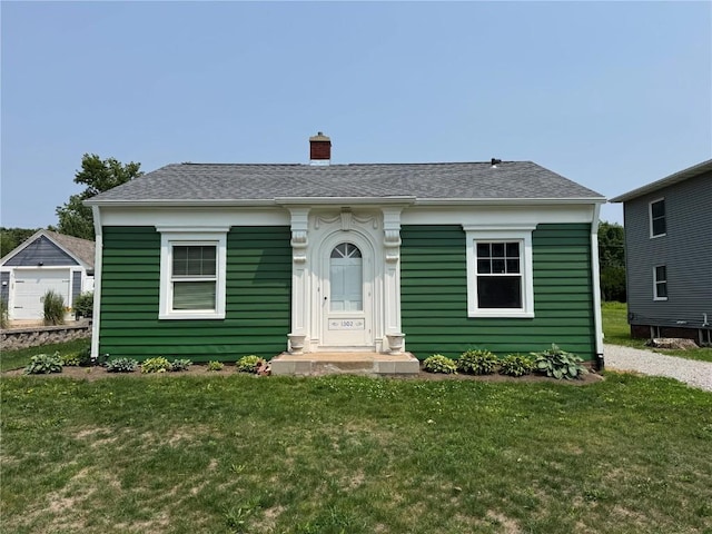 1302 Maplewood Dr NE, Cedar Rapids, IA 52402 - bungalow-style home with a chimney, a front yard, and a shingled roof