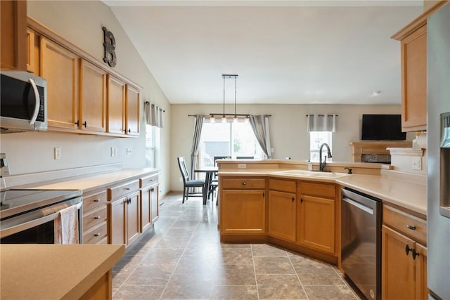 202 Jasper St, Marion, IA 52302 - kitchen with appliances with stainless steel finishes, a sink, a peninsula, light countertops, and vaulted ceiling