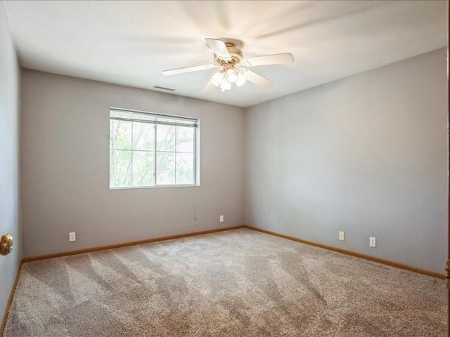 4619 1st Ave Unit 9, Cedar Rapids, IA 52404 - spare room featuring carpet, baseboards, and ceiling fan
