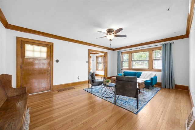 2251 Bever Ave SE, Cedar Rapids, IA 52403 - living room with a ceiling fan, light wood-style flooring, crown molding, and baseboards