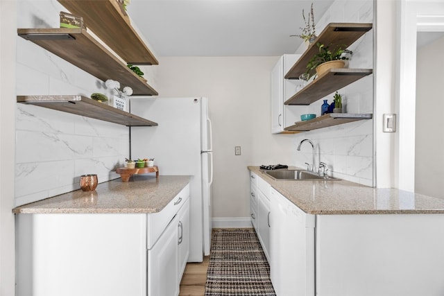 2251 Bever Ave SE, Cedar Rapids, IA 52403 - kitchen featuring open shelves, white appliances, a sink, and tasteful backsplash