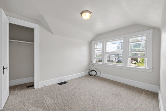2251 Bever Ave SE, Cedar Rapids, IA 52403 - additional living space with vaulted ceiling, carpet floors, and baseboards