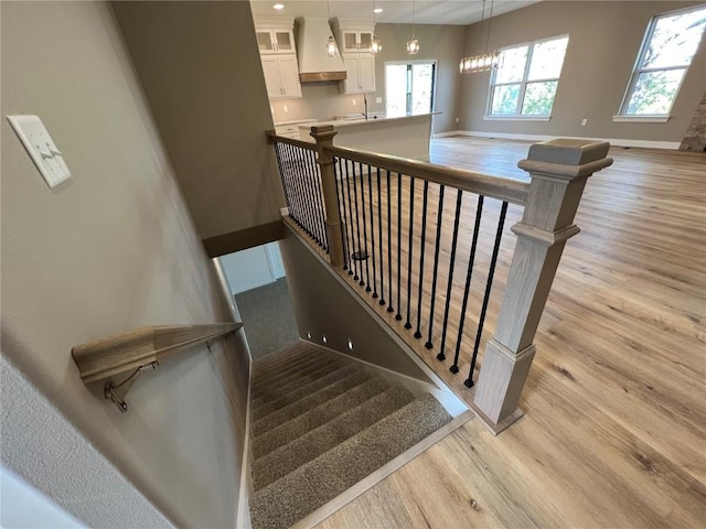 1417 Legend Dr, Tiffin, IA 52340 - stairs featuring wood finished floors, baseboards, and recessed lighting