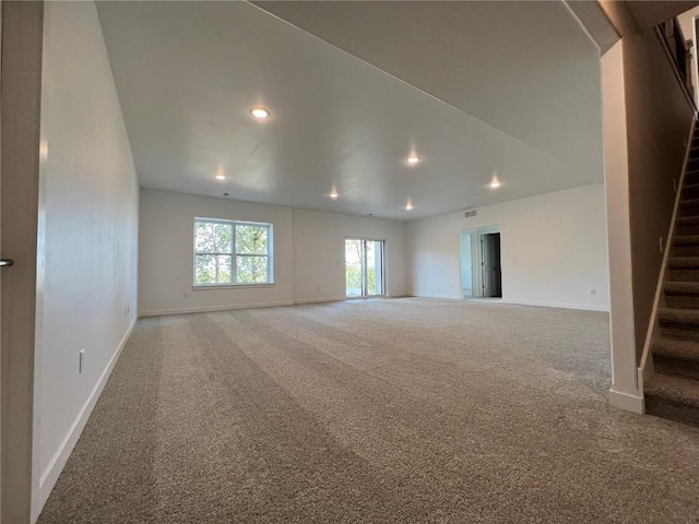 1417 Legend Dr, Tiffin, IA 52340 - spare room with stairway, carpet, recessed lighting, and baseboards