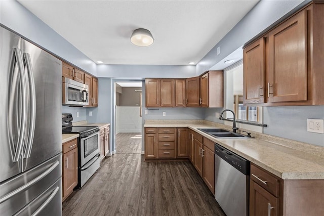3013 Ravenwood Ter NW, Cedar Rapids, IA 52405 - kitchen featuring stainless steel appliances, a sink, light countertops, dark wood-type flooring, and brown cabinets
