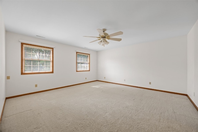 3629 Timberline Dr NE, Cedar Rapids, IA 52402 - empty room featuring a ceiling fan, light colored carpet, and baseboards